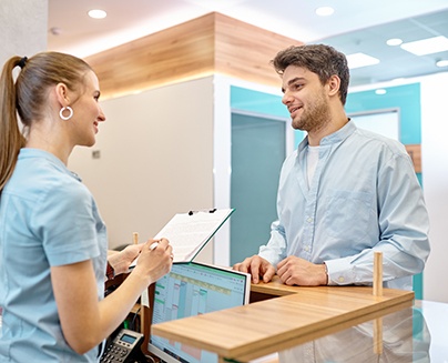 a patient speaking with a dental assistant