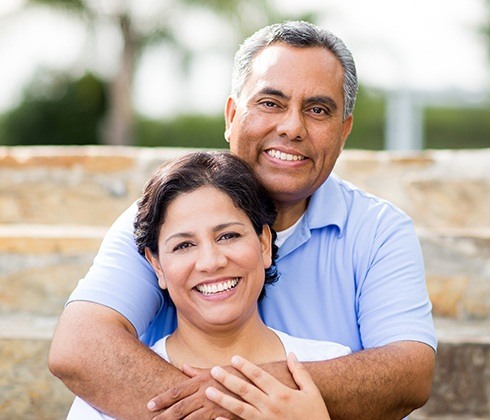Couple with dentures and partial dentures smiling together