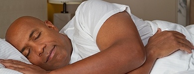 Man sleeping soundly thanks to sleep apnea therapy