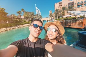 couple smiling on beach during summer vacation