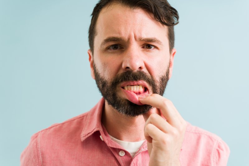 man suffering from gum disease 