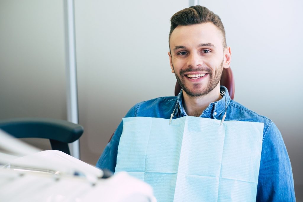 Young man smiling at dental checkup