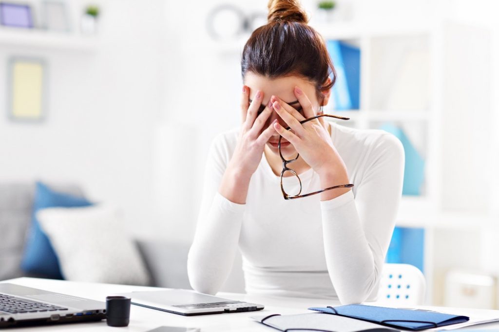 Closeup of woman feeling stressed at work