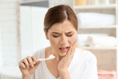 Woman in pain with a toothache before seeing a dentist