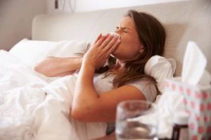 Woman blowing her nose